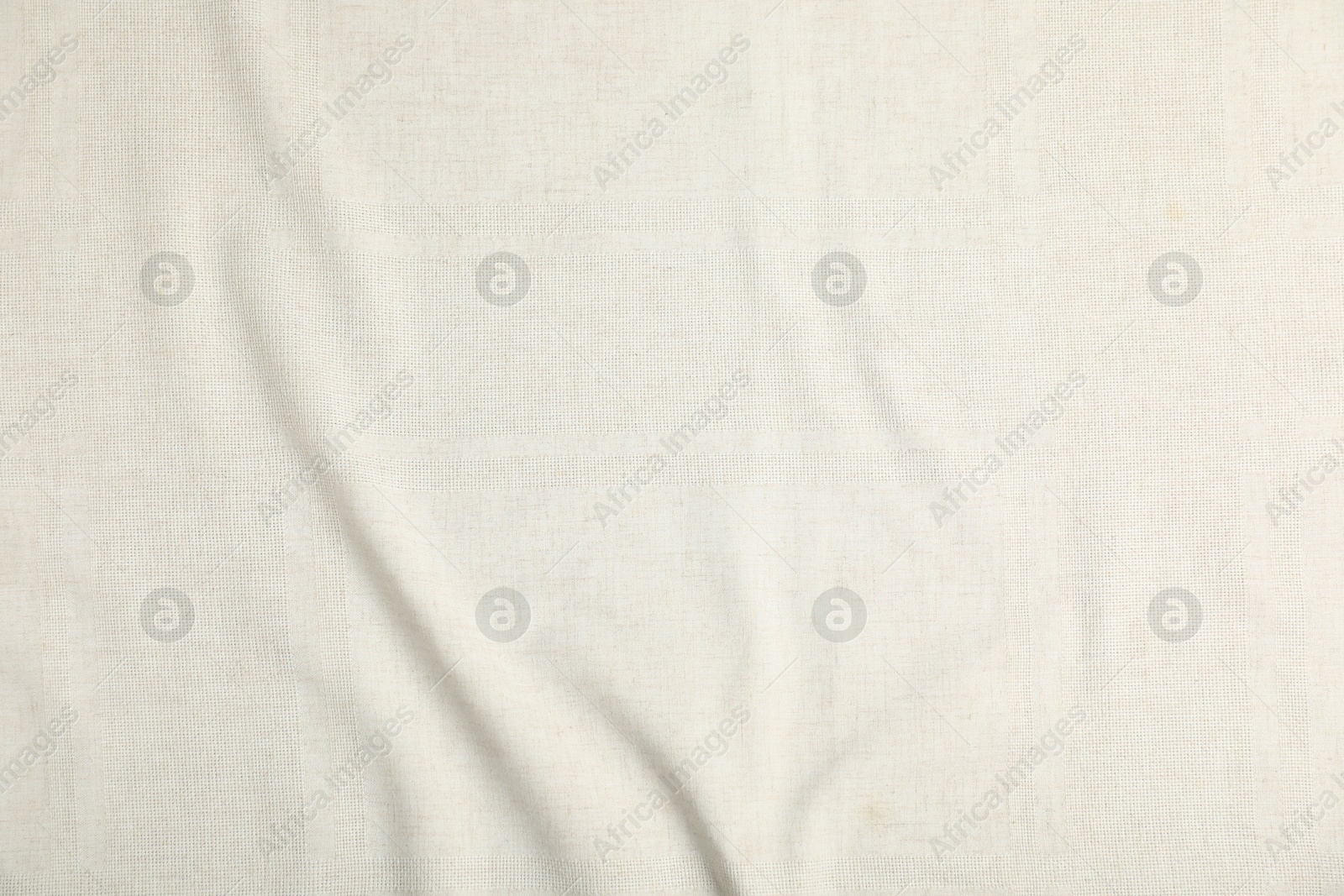 Photo of Texture of beige crumpled tablecloth as background, top view