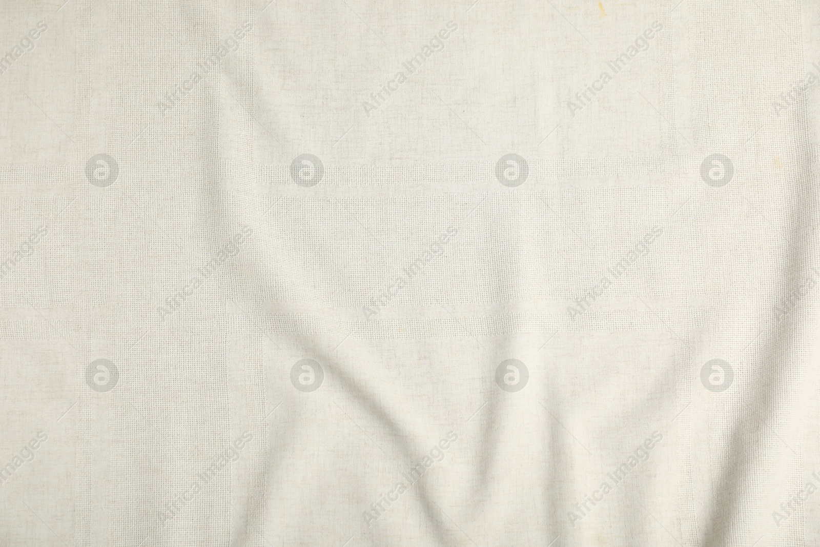 Photo of Texture of beige crumpled tablecloth as background, top view