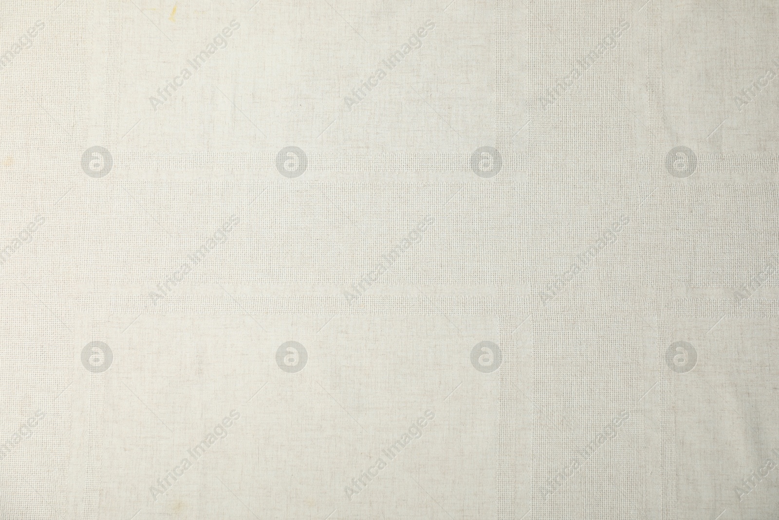 Photo of Texture of beige tablecloth as background, top view