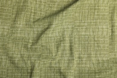 Photo of Texture of green crumpled tablecloth as background, top view