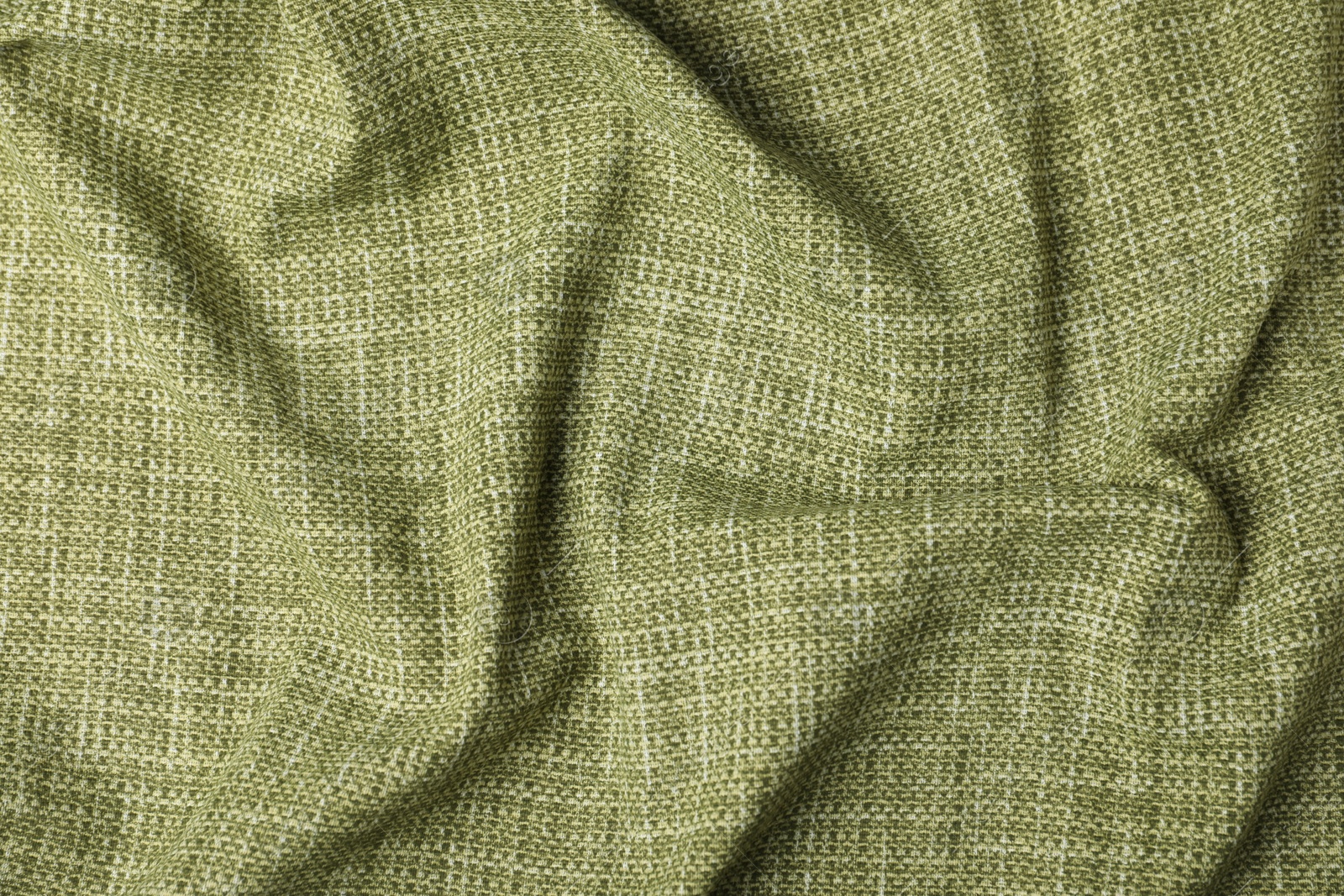 Photo of Texture of green crumpled tablecloth as background, top view