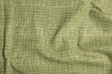 Photo of Texture of green crumpled tablecloth as background, top view