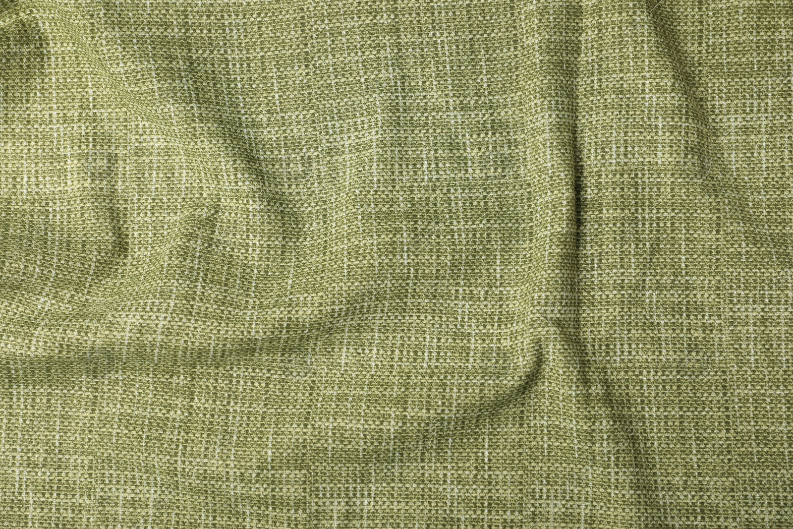 Photo of Texture of green crumpled tablecloth as background, top view