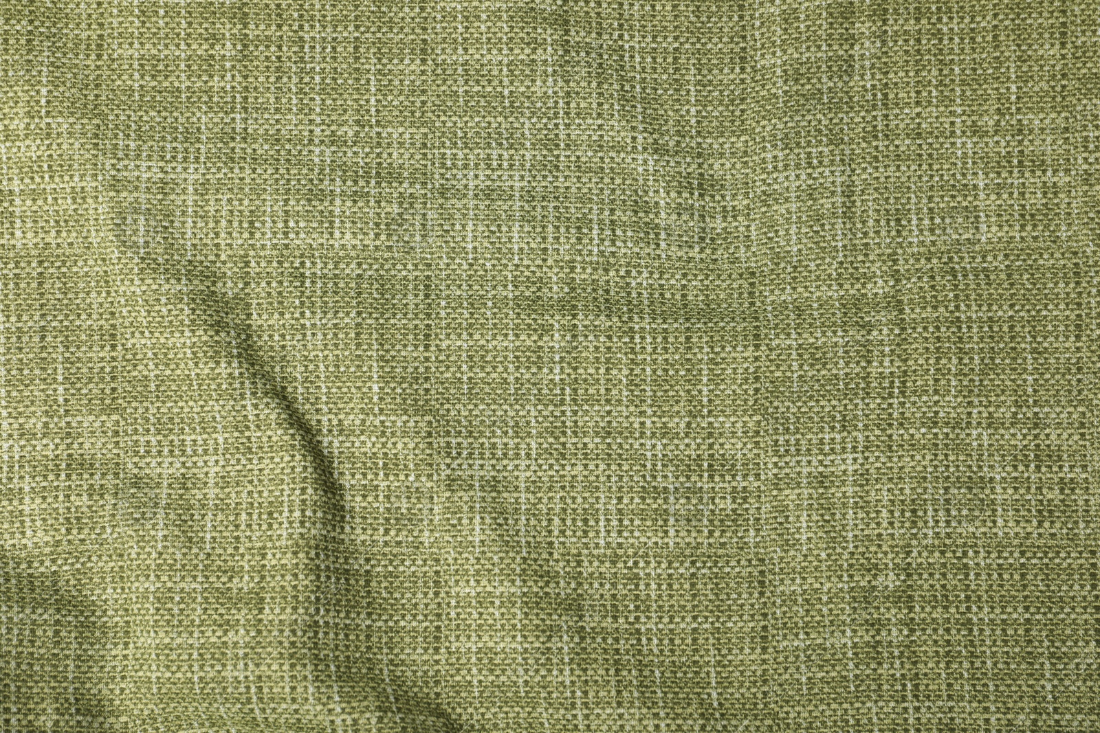 Photo of Texture of green crumpled tablecloth as background, top view