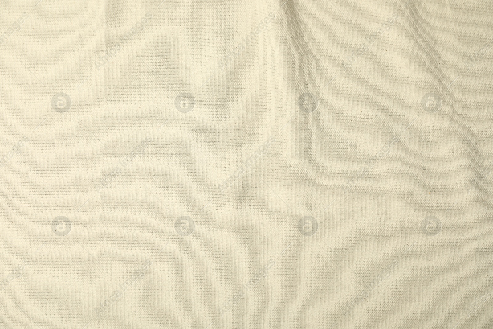 Photo of Texture of beige crumpled tablecloth as background, top view