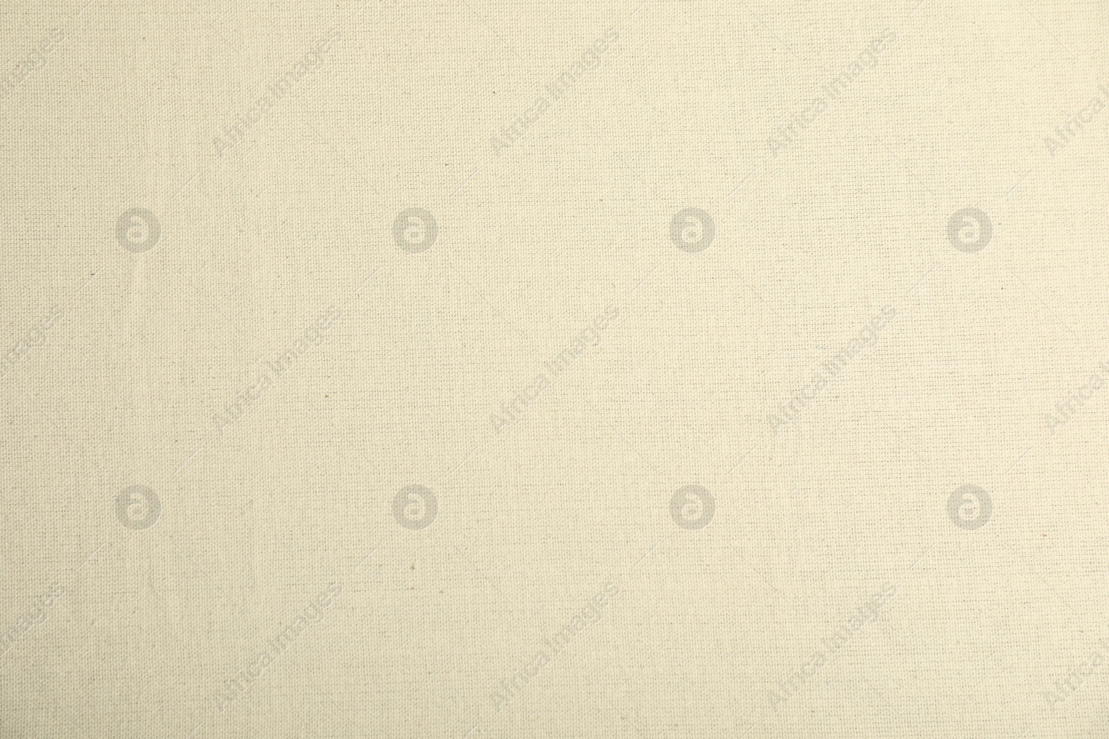 Photo of Texture of beige tablecloth as background, top view