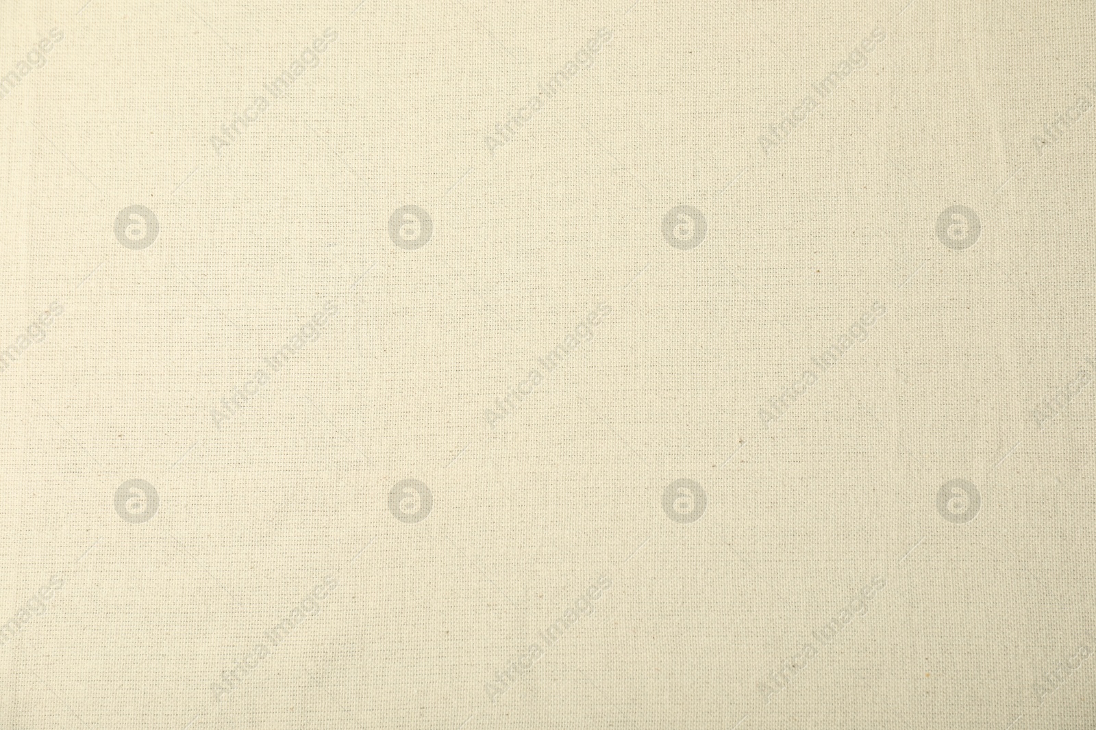 Photo of Texture of beige tablecloth as background, top view