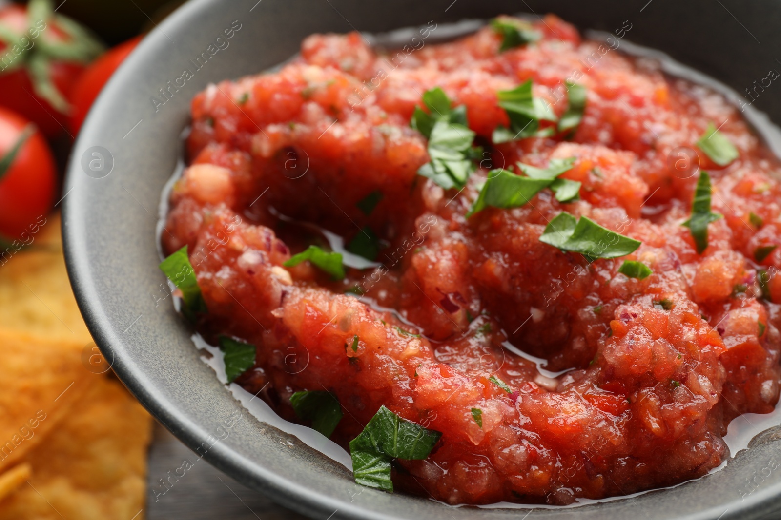 Photo of Delicious spicy salsa sauce in bowl on table, closeup