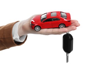 Photo of Woman with car model and key on white background, closeup. Buying auto