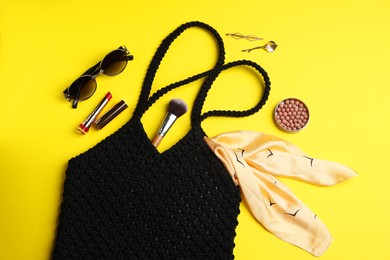 Photo of Flat lay composition with macrame shopping bag and makeup products on yellow background