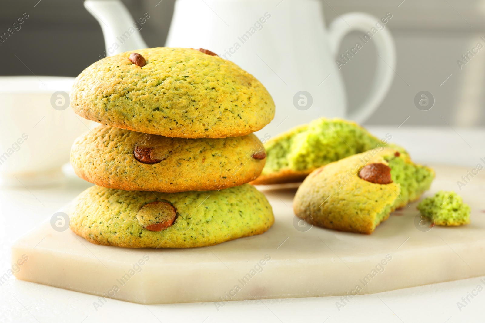 Photo of Delicious mint chocolate chip cookies on white table, closeup