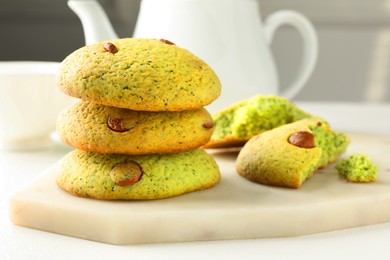 Photo of Delicious mint chocolate chip cookies on white table, closeup