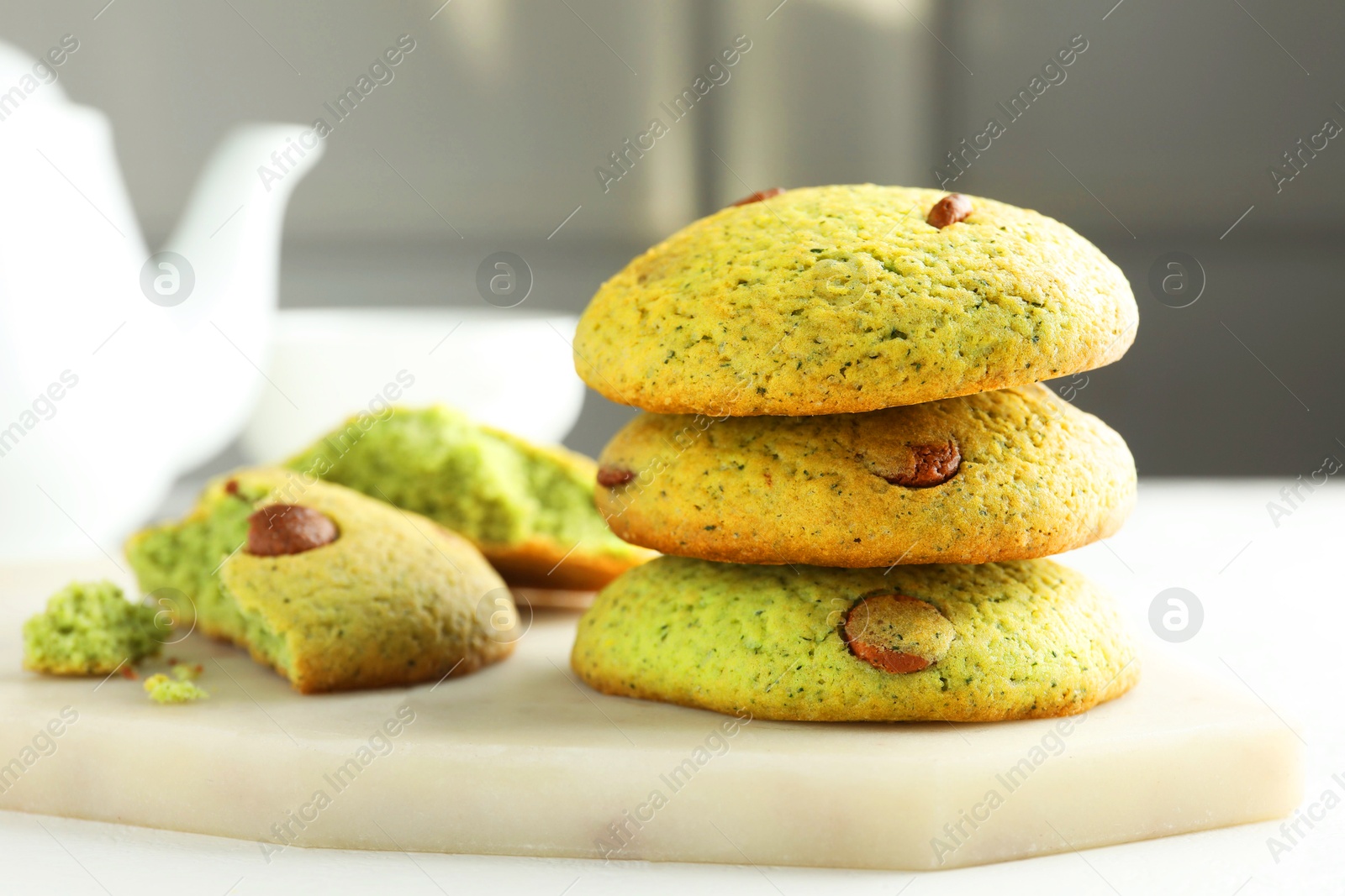 Photo of Delicious mint chocolate chip cookies on white table, closeup