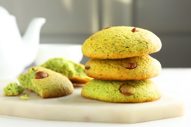 Photo of Delicious mint chocolate chip cookies on white table, closeup