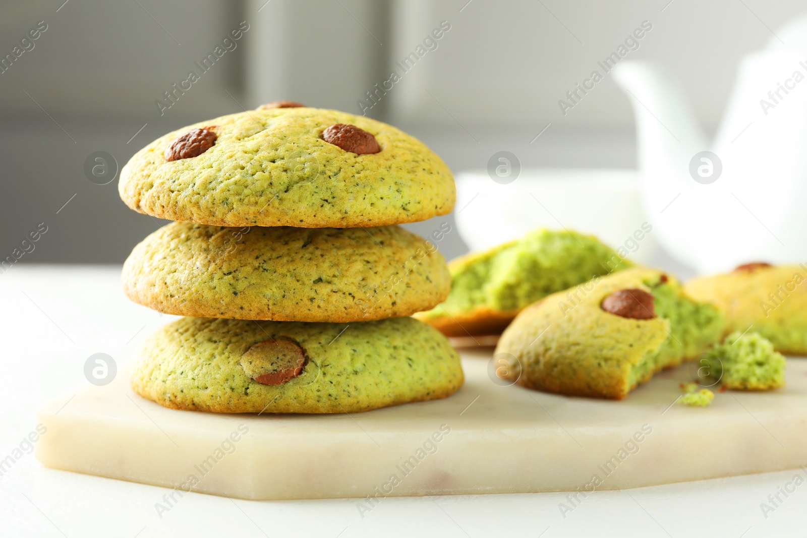 Photo of Delicious mint chocolate chip cookies on white table, closeup