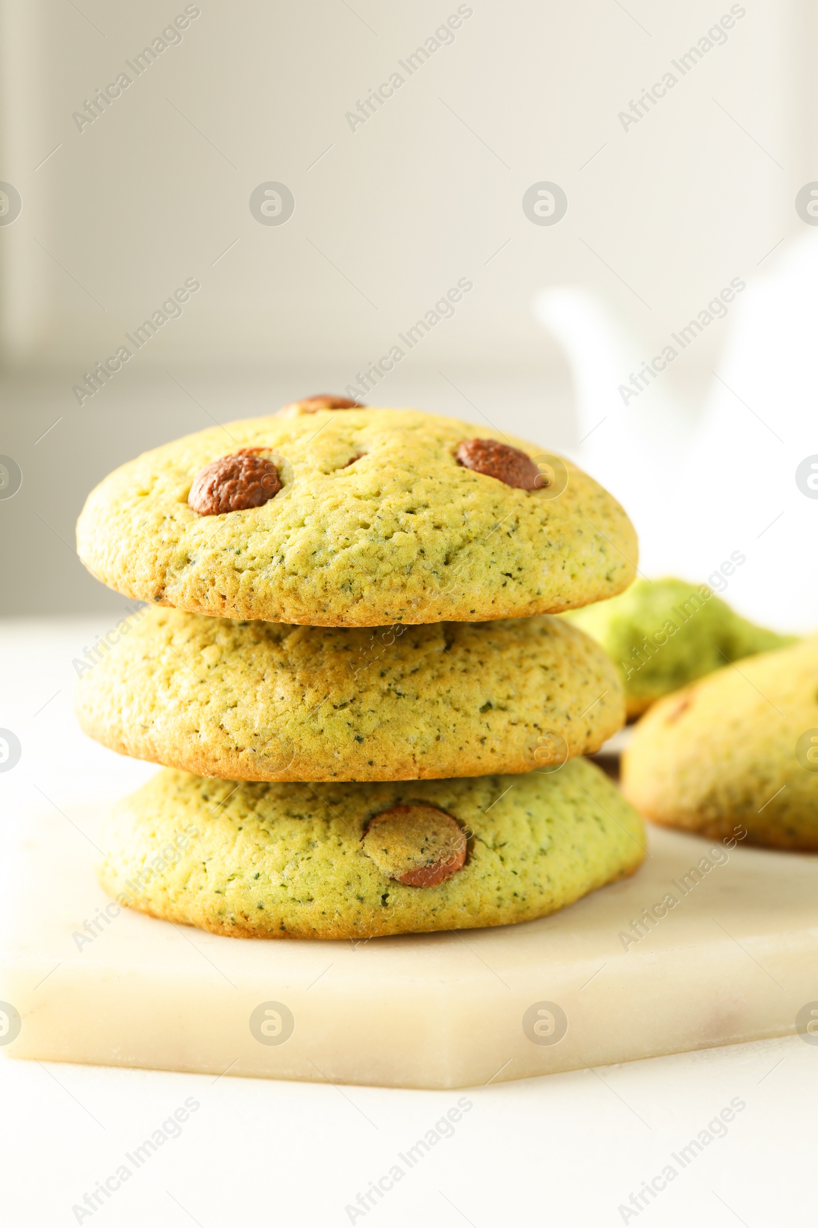 Photo of Delicious mint chocolate chip cookies on white table, closeup