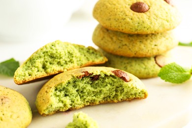 Photo of Delicious mint chocolate chip cookies on white table, closeup