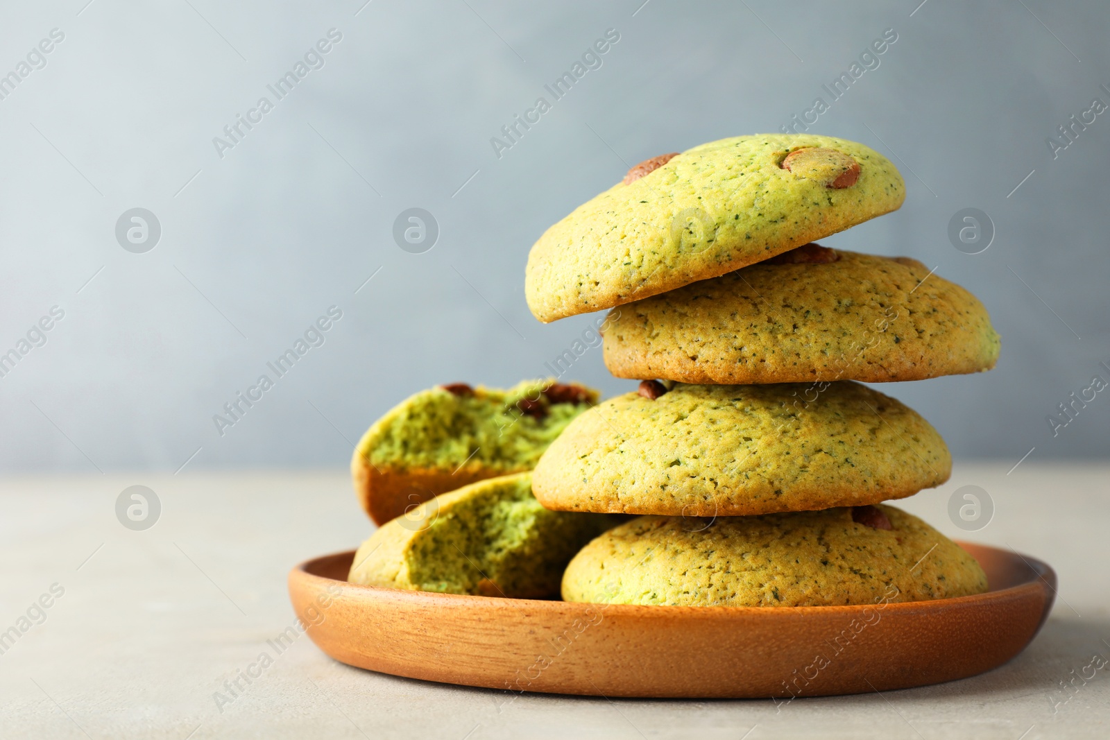 Photo of Delicious mint chocolate chip cookies on light table, closeup