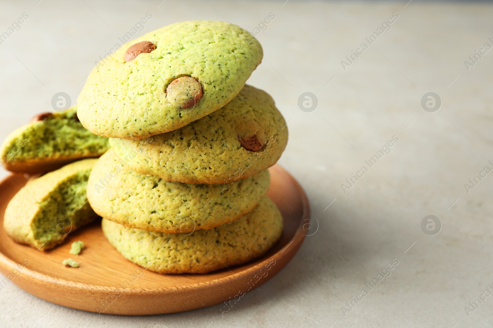 Photo of Delicious mint chocolate chip cookies on light table, closeup. Space for text