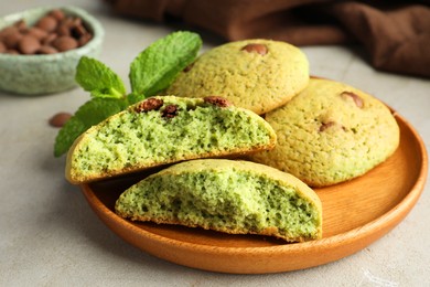 Photo of Delicious mint chocolate chip cookies on light table, closeup