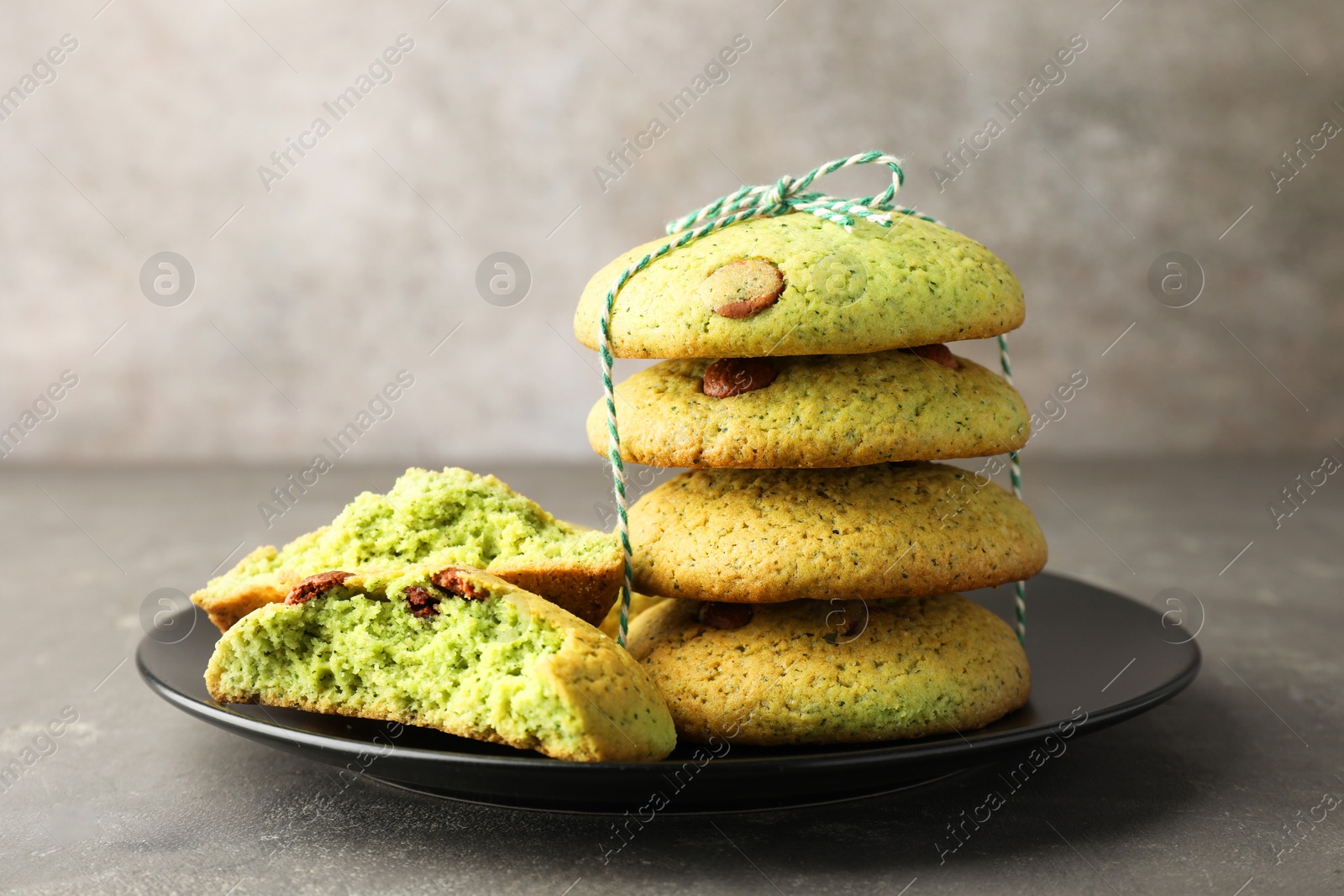 Photo of Delicious mint chocolate chip cookies on grey table, closeup