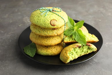 Photo of Delicious mint chocolate chip cookies on grey table, closeup