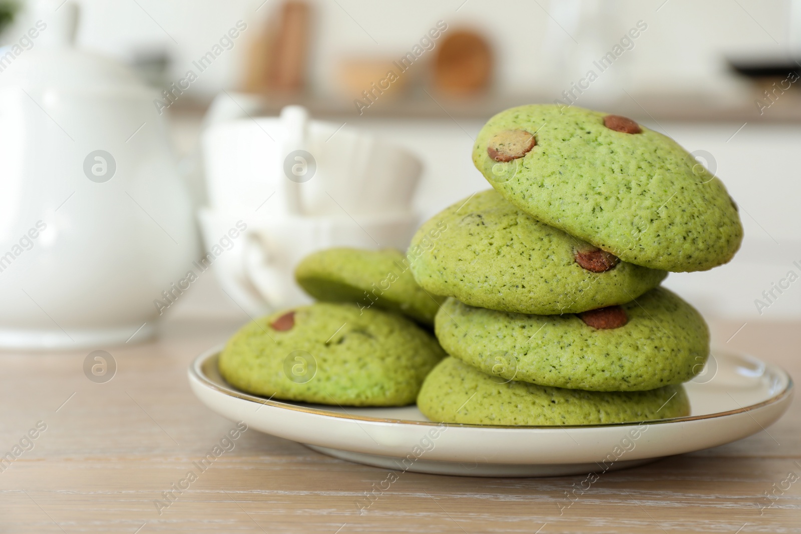 Photo of Delicious mint chocolate chip cookies on wooden table, closeup