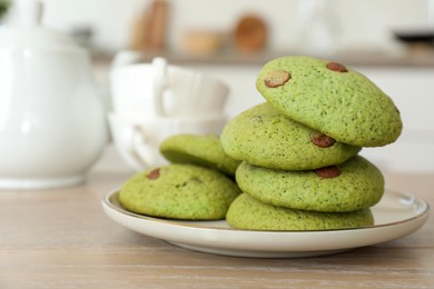 Photo of Delicious mint chocolate chip cookies on wooden table, closeup