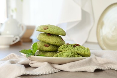 Photo of Delicious mint chocolate chip cookies on wooden table, closeup