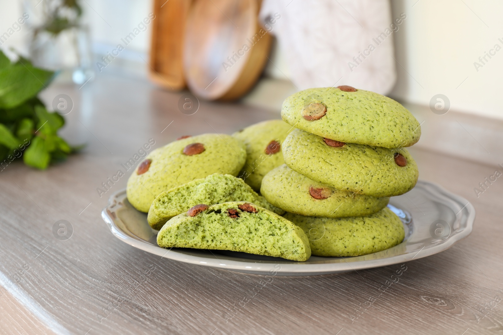 Photo of Delicious mint chocolate chip cookies on wooden table