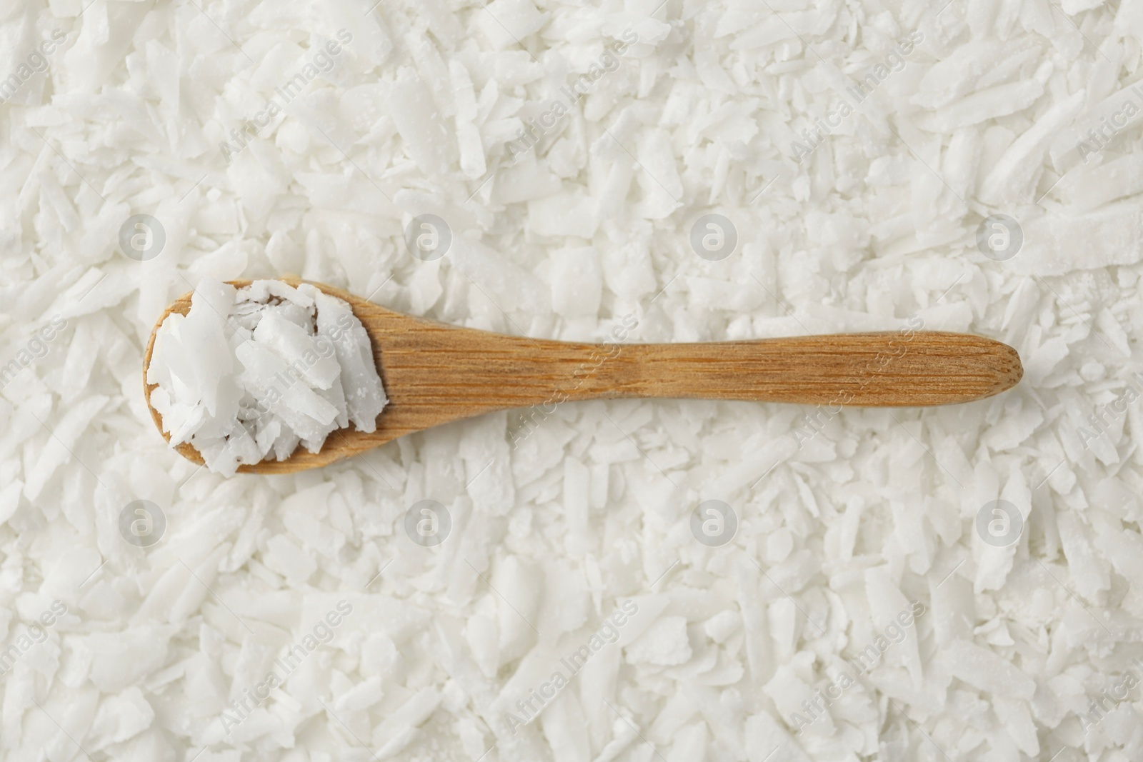 Photo of White soy wax flakes and spoon, top view