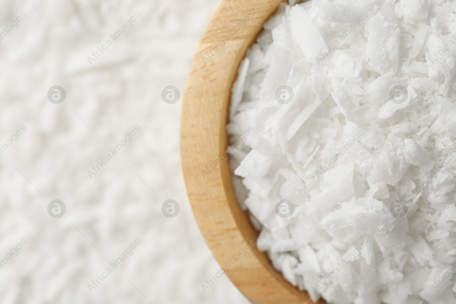 Photo of White soy wax flakes and bowl, top view