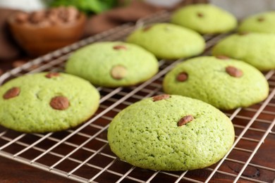 Photo of Delicious mint chocolate chip cookies on wooden table, closeup