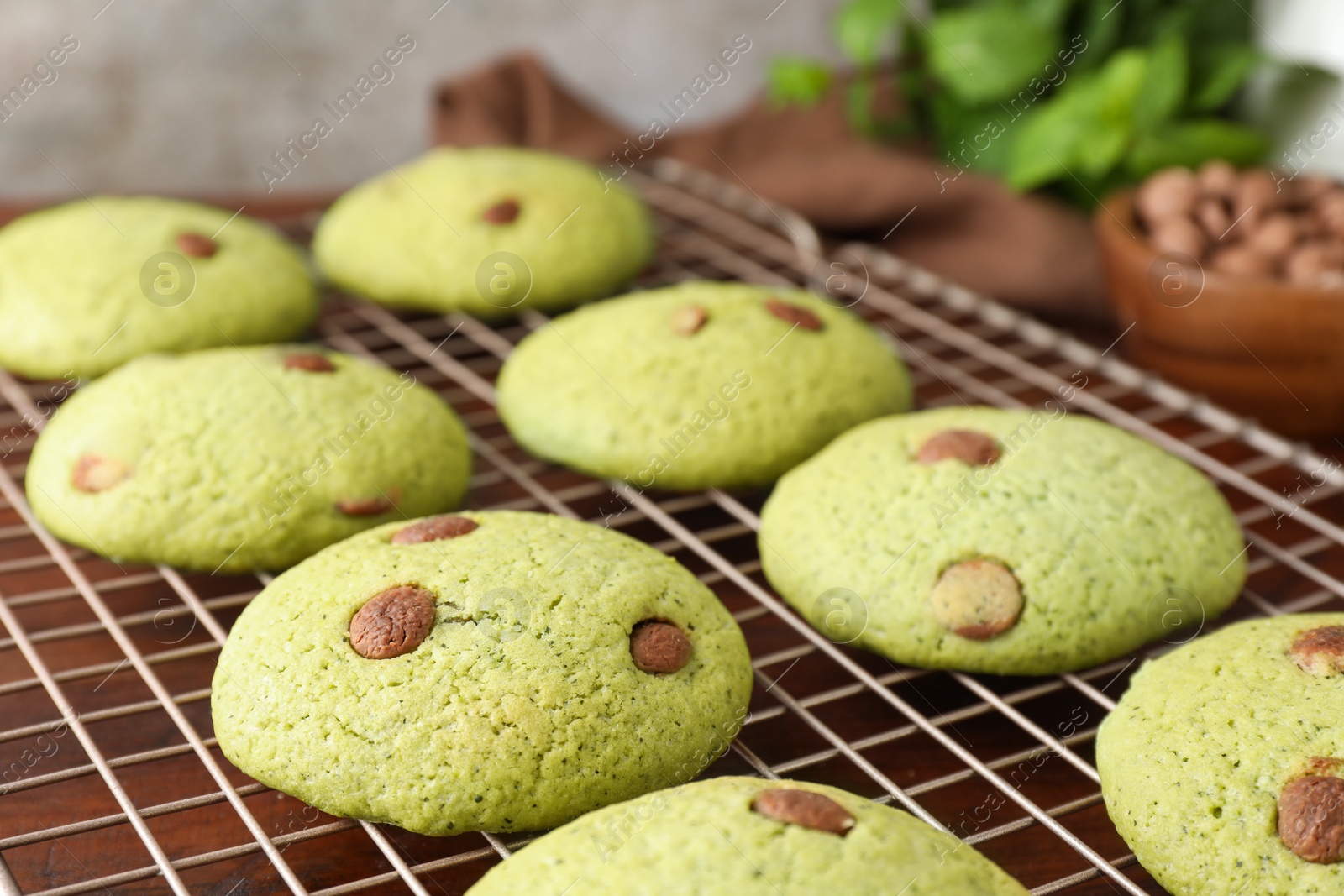 Photo of Delicious mint chocolate chip cookies on wooden table, closeup