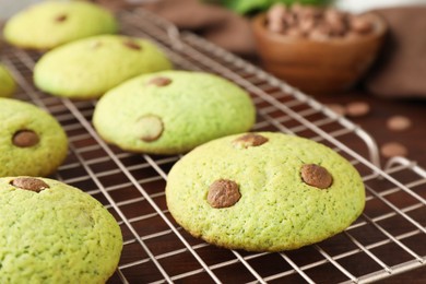 Photo of Delicious mint chocolate chip cookies on wooden table, closeup