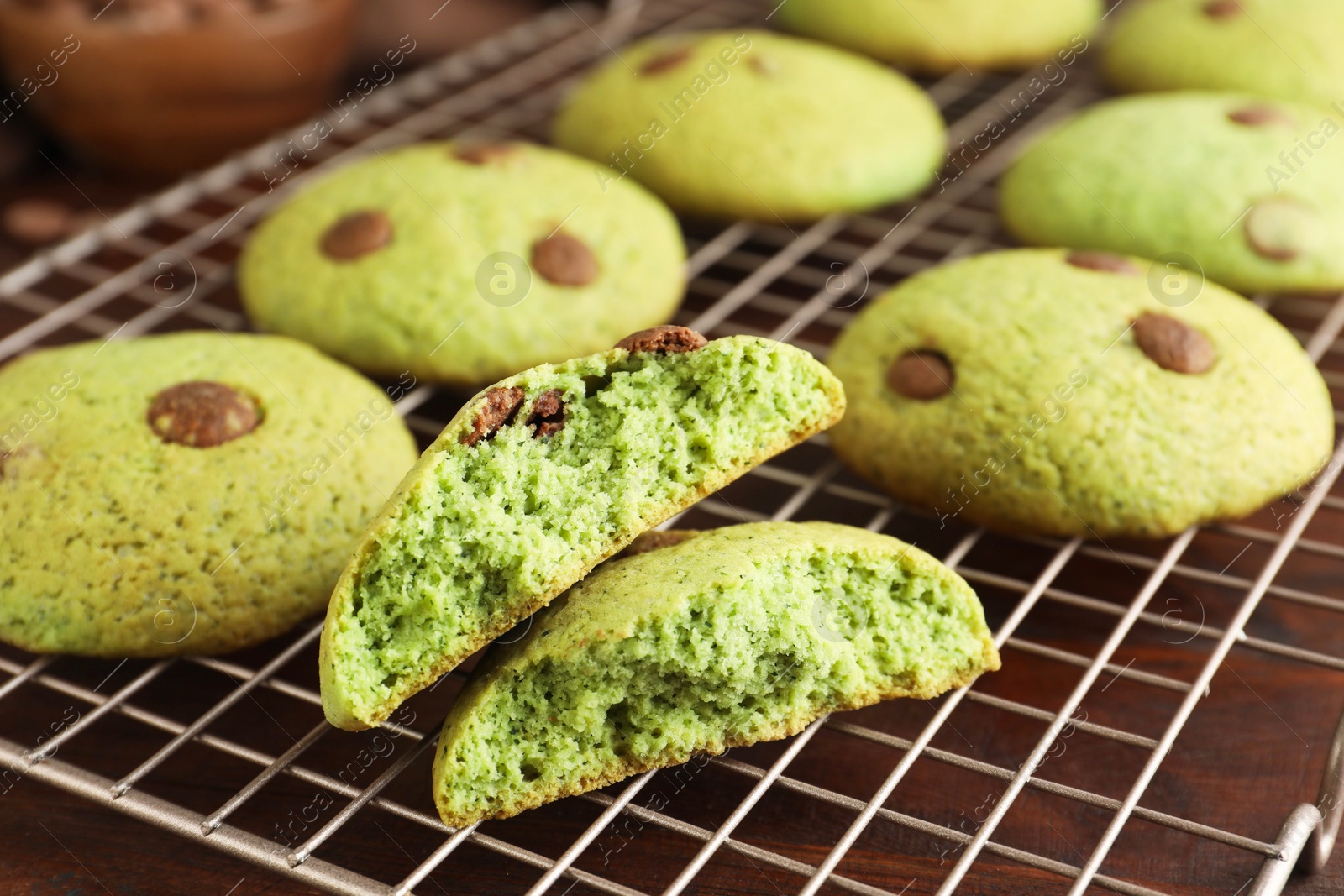 Photo of Delicious mint chocolate chip cookies on wooden table, closeup