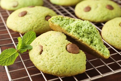 Photo of Delicious mint chocolate chip cookies on wooden table, closeup