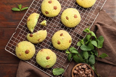 Photo of Delicious mint chocolate chip cookies on wooden table, flat lay