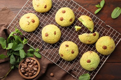 Photo of Delicious mint chocolate chip cookies on wooden table, flat lay