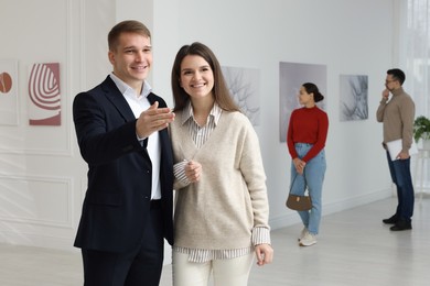 Photo of Happy woman and man visiting art gallery