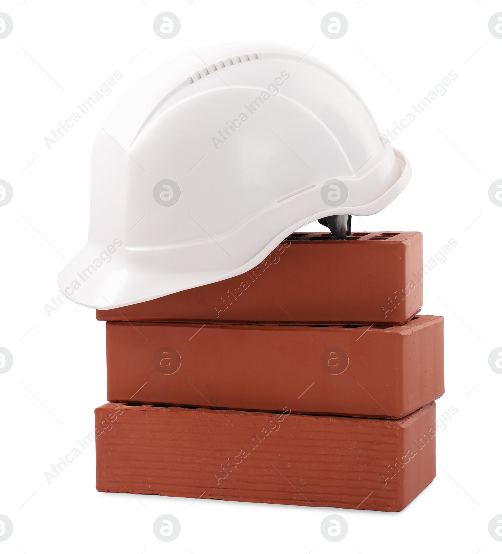 Photo of Hardhat with bricks isolated on white. Construction materials and safety equipment