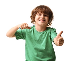 Photo of Cute boy with toothbrush showing thumbs up on white background