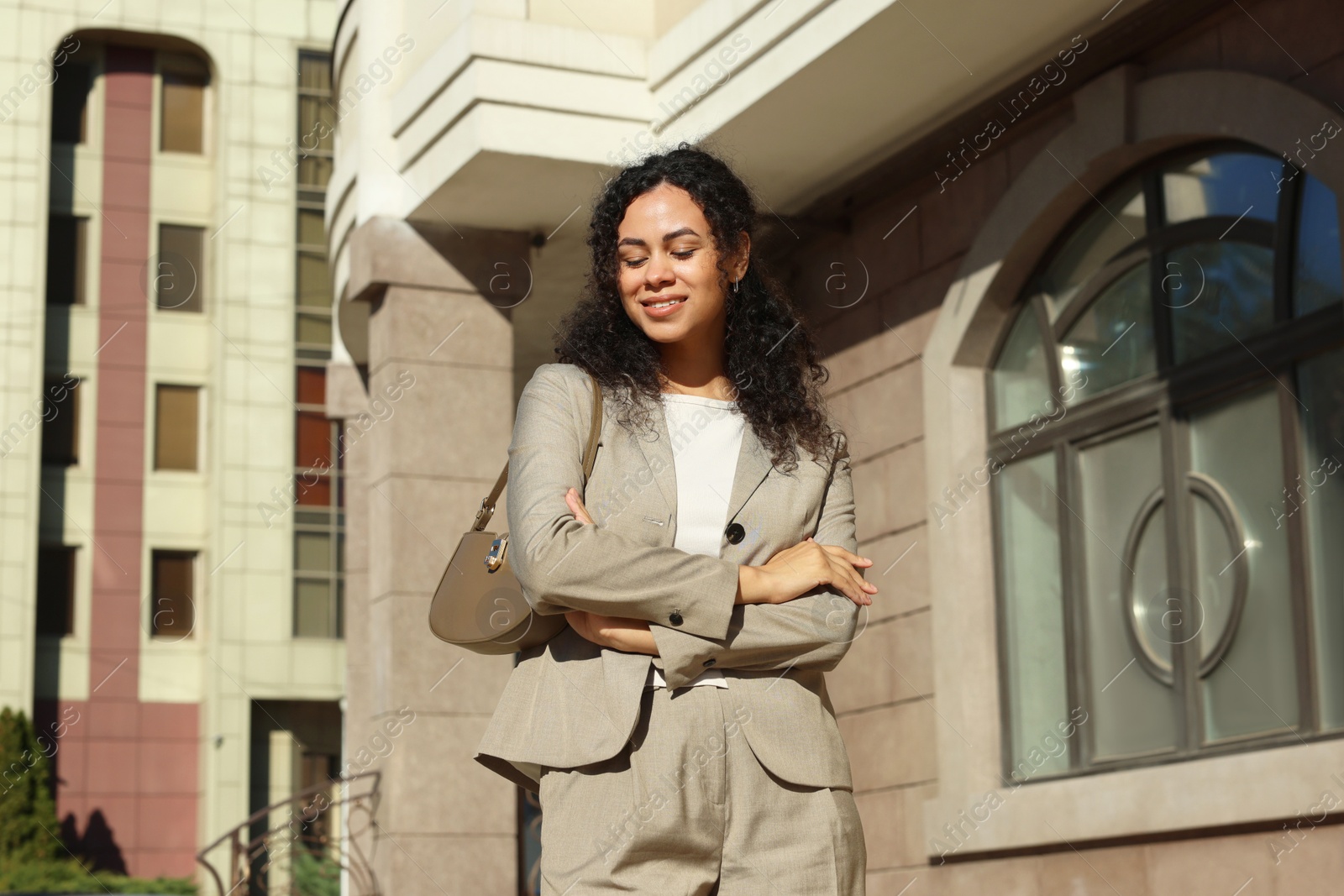 Photo of Portrait of young woman wearing stylish suit outdoors