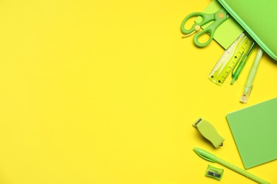 Photo of Different stationery on yellow background, flat lay. Space for text