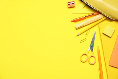 Photo of Different stationery on yellow background, flat lay. Space for text