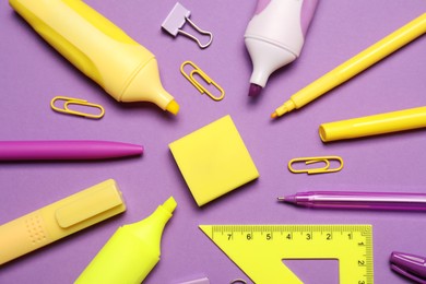 Photo of Many different stationery on purple background, flat lay