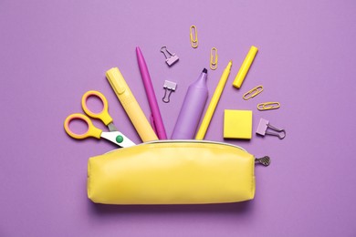 Photo of Pencil case with different stationery on purple background, flat lay
