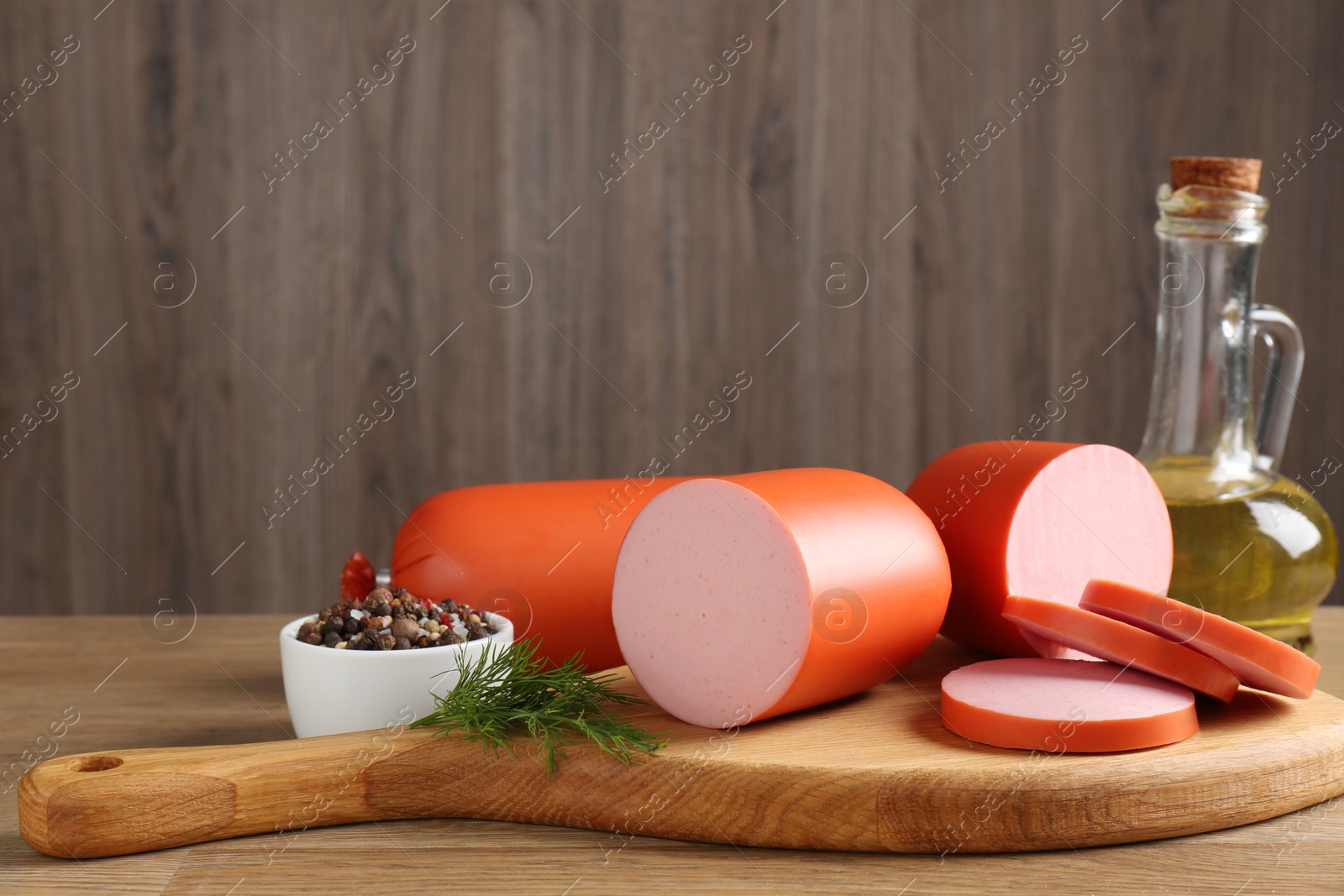 Photo of Tasty boiled sausages and spices on wooden table