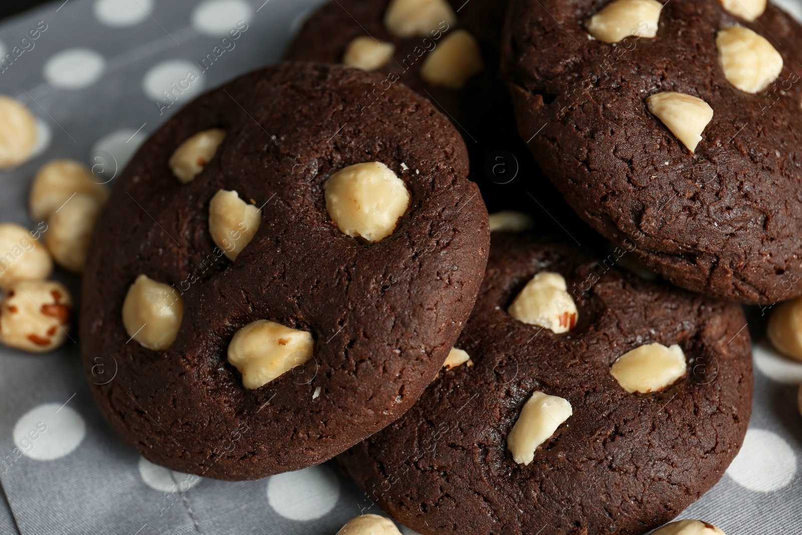 Photo of Delicious chocolate cookies with hazelnuts on table, closeup