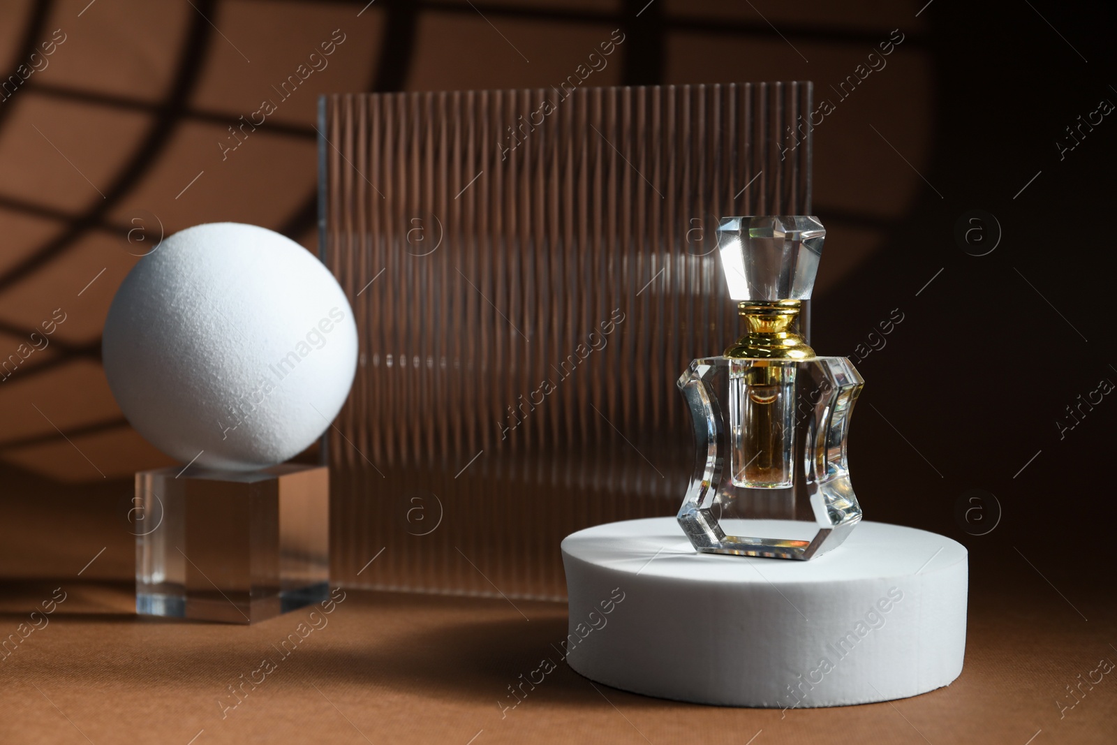 Photo of Stylish presentation of perfume bottle on brown background